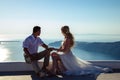 Beautiful bride and groom in their summer wedding day on greek island Santorini Royalty Free Stock Photo