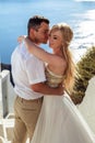 Beautiful bride and groom in their summer wedding day on greek island Santorini Royalty Free Stock Photo