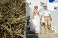 Beautiful bride and groom in their summer wedding day on greek island Santorini Royalty Free Stock Photo