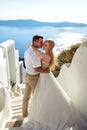 Beautiful bride and groom in their summer wedding day on greek island Santorini Royalty Free Stock Photo