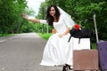 Beautiful bride hitch-hike Royalty Free Stock Photo