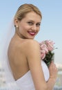 Beautiful Bride Holding Flower Bouquet Against Sky Royalty Free Stock Photo