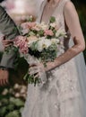 A beautiful bride holding her spouse hands