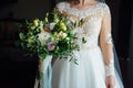 Beautiful bride is holding a wedding colorful bouquet. Royalty Free Stock Photo