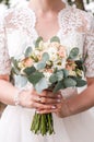 Beautiful bride is holding a wedding colorful bouquet. Beauty of colored flowers. Close-up bunch of florets. Bridal accessories. F Royalty Free Stock Photo