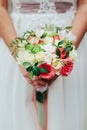 Beautiful bride is holding a wedding colorful bouquet. Beauty of colored flowers. Close-up bunch of florets. Royalty Free Stock Photo