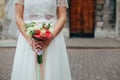 Beautiful bride is holding a wedding colorful bouquet. Beauty of colored flowers. Close-up bunch of florets. Royalty Free Stock Photo