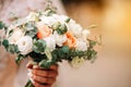 Beautiful bride is holding a wedding colorful bouquet. Beauty of colored flowers. Close-up bunch of florets.