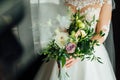 Beautiful bride is holding a wedding colorful bouquet. Royalty Free Stock Photo