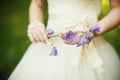 Beautiful bride in luxurious wedding dress with purple lavender fl