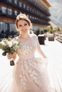 Beautiful bride in a nice dress stands on the terasse with great mountain view in Georgia Royalty Free Stock Photo