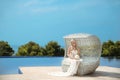 Beautiful Bride Portrait holding wedding bouquet posing in formal prom lace mermaid dress. Beautiful blond sitting on beach sofa