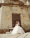 Beautiful bride posing in her wedding day near the old castle Royalty Free Stock Photo