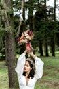 Beautiful bride posing in a wedding white dress holding a bridal bouquet over her head Royalty Free Stock Photo