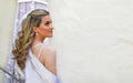 Beautiful bride profile in front of her wedding dress - bridal style