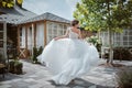 Beautiful bride running away in the garden