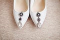 Beautiful bride Shoes with earrings. Wedding details. Royalty Free Stock Photo