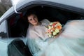 Beautiful bride sitting in the car Royalty Free Stock Photo