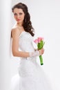 Beautiful bride standing near white column