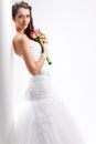 Beautiful bride standing near white column