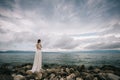 Beautiful Bride standing by the Sea. Royalty Free Stock Photo