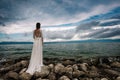 Beautiful Bride standing by the Sea. Royalty Free Stock Photo