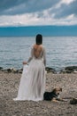 Beautiful Bride standing by the Sea. Royalty Free Stock Photo