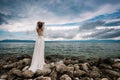 Beautiful Bride standing by the Sea. Royalty Free Stock Photo