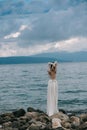 Beautiful Bride standing by the Sea. Royalty Free Stock Photo