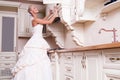 Beautiful bride stands in the kitchen