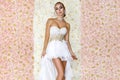 Beautiful bride in a stunning wedding dress with lace. Beauty young woman on a background of roses - Image