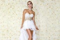 Beautiful bride in a stunning wedding dress with lace. Beauty young woman on a background of roses - Image