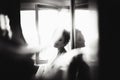 Beautiful bride style. Wedding girl stand in luxury wedding dress near window. Black and white