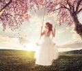 Beautiful Bride swing in the spring meadow