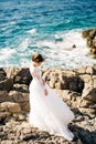 beautiful bride in tender wedding dress on the rocky beach of the Mamula island