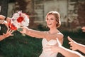 Beautiful bride throws wedding bouquet to her friends Royalty Free Stock Photo