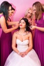 Beautiful Bride together with 4 bridesmaids in violet similar dresses