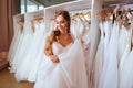 Beautiful bride is trying on an elegant wedding dress