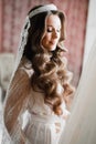 Beautiful bride wearing fashion wedding dress with feathers with luxury delight make-up and hairstyle, studio indoor