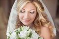 Beautiful bride with wedding bouquet of flowers. Makeup. Blond c Royalty Free Stock Photo