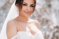 Beautiful bride in a wedding dress with a bouquet on the top of the salt mountains. A stunning young bride with curly hair .