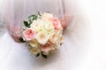 Beautiful bride in a wedding dress holding a bouquet of pink roses. White background. Royalty Free Stock Photo