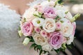 Beautiful bride in a wedding dress holding a bouquet of red tulips. White background. Royalty Free Stock Photo