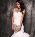 Beautiful bride in wedding dress holding decorative heart Royalty Free Stock Photo