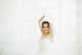 Beautiful bride in wedding dress with long full skirt, white background, dance and smile Royalty Free Stock Photo