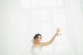 Beautiful bride in wedding dress with long full skirt, white background, dance and smile Royalty Free Stock Photo