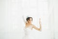 Beautiful bride in wedding dress with long full skirt, white background, dance and smile Royalty Free Stock Photo