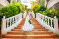 Beautiful bride in wedding dress with long train standing on the Royalty Free Stock Photo