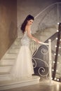 Beautiful Bride in wedding dress posing on staircase. Elegant br Royalty Free Stock Photo