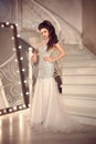 Beautiful Bride in wedding dress posing on staircase. Elegant br Royalty Free Stock Photo